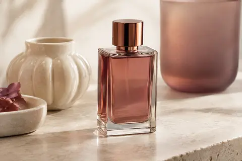 Flacon élégant d’eau de parfum Afnan 9 PM posé sur une surface claire dans un décor de beauté raffiné